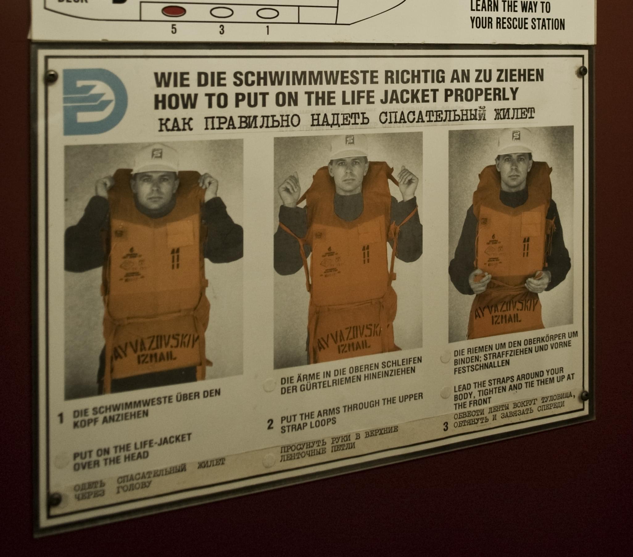 Instructions on how to put on a lifevest with photos of an adult male putting it on