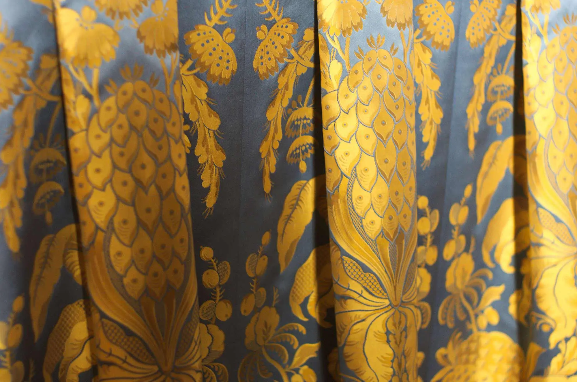 A very ornate gold and blue curtain