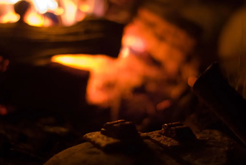 A couple of graham wafers with chocolate melting on them in front of a fire